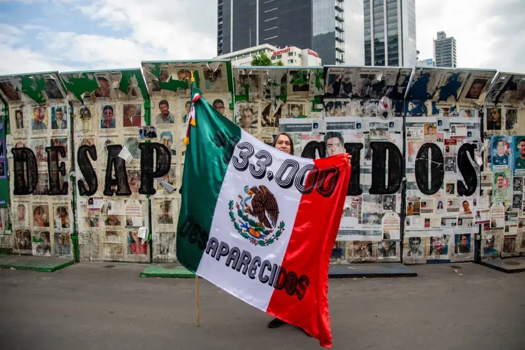 Familiares y colectivos de búsqueda sostienen fotografías de personas desaparecidas en México
